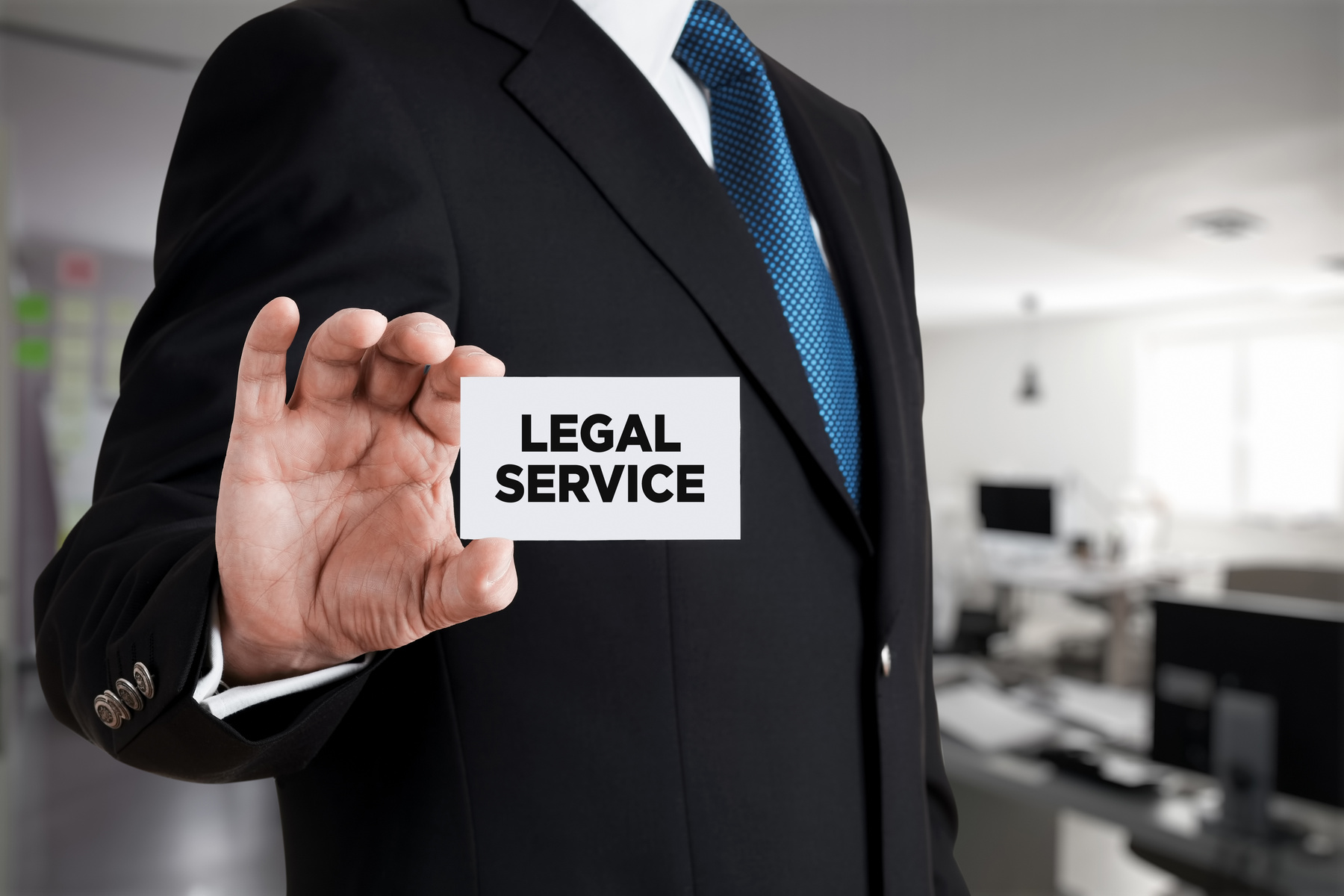 Businessman shows a business card with the message legal service. Legal service or advice support